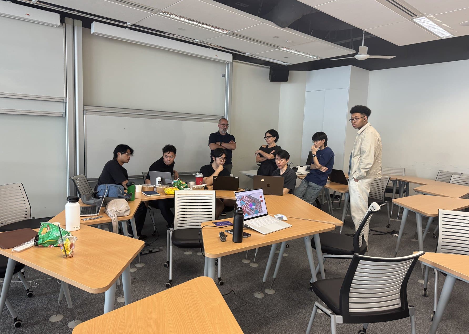 Workshop participants and tutors around the studio tables at SUTD